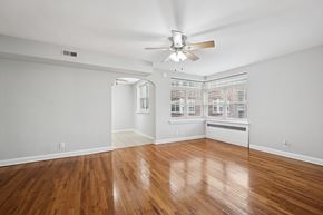 Philadelphia apartment for rent - A room with a ceiling fan and wooden flooring.