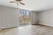 Norristown apartment for rent - A room with a ceiling fan and sliding glass doors leading to a balcony.