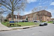 Philadelphia apartment for rent - A large building with a sign that says "7400 Roosevelt" in front of it.