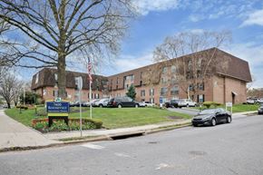 Philadelphia apartment for rent - A large building with a sign that says "7400 Roosevelt" in front of it.
