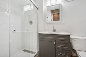Philadelphia apartment for rent - A white bathroom with a white tub and a white sink.