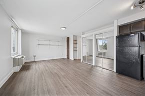 Philadelphia apartment for rent - A spacious kitchen with a black fridge and wooden flooring.