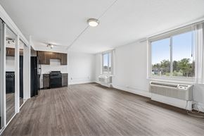 Philadelphia apartment for rent - A spacious room with wooden flooring and large windows.
