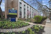 Philadelphia apartment for rent - A sign for Academia Suites Apartments Homes is in front of a building.
