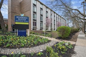 Philadelphia apartment for rent - A sign for Academia Suites Apartments Homes is in front of a building.