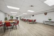 Philadelphia apartment for rent - A conference room with red chairs and a long table.