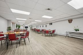 Philadelphia apartment for rent - A conference room with red chairs and a long table.