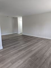 Philadelphia apartment for rent - A room with wooden flooring and a doorway leading to another room.