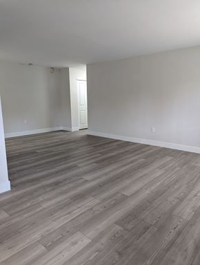 Philadelphia apartment for rent - A room with wooden flooring and a doorway leading to another room.