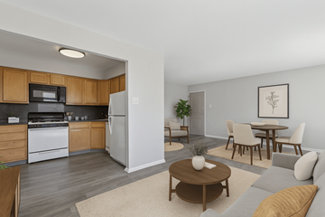 Warrington apartment for rent - A kitchen with wooden cabinets and a white refrigerator is shown.