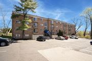 Elkins Park apartment for rent - A parking lot in front of a brick apartment building.