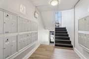 Elkins Park apartment for rent - A hallway with a staircase and lockers on both sides.