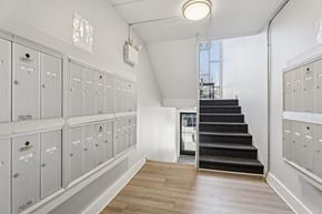 Elkins Park apartment for rent - A hallway with a staircase and lockers on both sides.