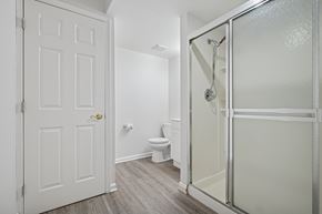 Philadelphia apartment for rent - A white door is on the left and a glass shower door is on the right.