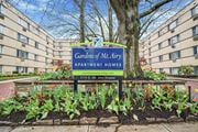 Philadelphia apartment for rent - A sign for Gardens of Mr. Arry Apartment Homes is in front of a building.