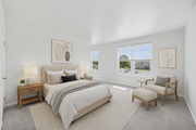 Philadelphia townhouse for rent - A bedroom with a large bed, a chair, and a table with lamps.