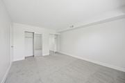 Philadelphia apartment for rent - A large empty room with carpeted floor and white walls.