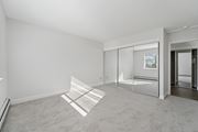 Philadelphia apartment for rent - A room with a carpeted floor and a glass door leading to another room.