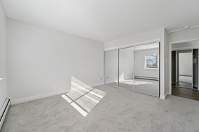 Philadelphia apartment for rent - A room with a carpeted floor and a glass door leading to another room.