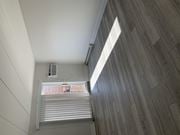 Elkins Park apartment for rent - an air conditioning unit sits on a wooden floor in a room with white walls and wood floors
