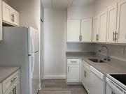 Elkins Park apartment for rent - an empty kitchen with white cabinets and white appliances