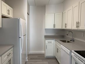 Elkins Park apartment for rent - an empty kitchen with white cabinets and white appliances