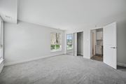 Philadelphia apartment for rent - A spacious room with a carpeted floor and a view of the outdoors through a window.