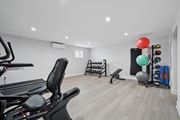 Philadelphia apartment for rent - A home gym with a treadmill, weights, and exercise balls.