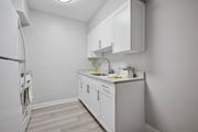 Philadelphia apartment for rent - A small kitchen with white cabinets and a white fridge.