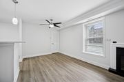 Huntingdon Valley apartment for rent - A room with a fireplace and a ceiling fan.