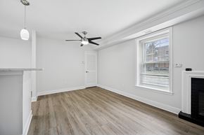 Huntingdon Valley apartment for rent - A room with a fireplace and a ceiling fan.