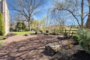 Abington apartment for rent - A backyard with a gravel path and a large rock in the middle.