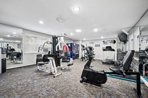 Philadelphia apartment for rent - A gym with a variety of equipment including a leg press machine.
