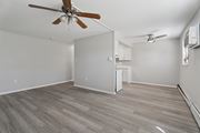 Roslyn apartment for rent - A room with a ceiling fan and a refrigerator.