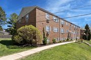 Roslyn apartment for rent - A brick apartment building with a green lawn in front.