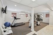 Roslyn apartment for rent - A gym with a treadmill, exercise bike, and weights.