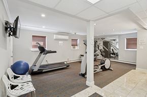 Roslyn apartment for rent - A gym with a treadmill, exercise bike, and weights.