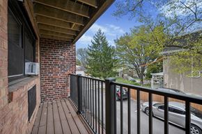 Philadelphia apartment for rent - A balcony with a black railing and a brick wall.