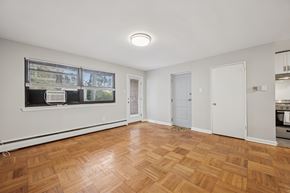 Philadelphia apartment for rent - A room with wooden flooring and a window with blinds.