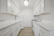 Landsdale apartment for rent - A white kitchen with a refrigerator, stove, and sink.