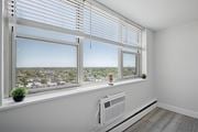 Philadelphia apartment for rent - A room with a window overlooking a cityscape and a white radiator on the floor.