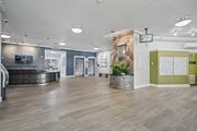 Philadelphia apartment for rent - A spacious office lobby with a reception desk and a calendar on the wall.