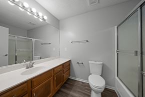Lees Summit apartment for rent - A white toilet sits next to a sink in a bathroom.