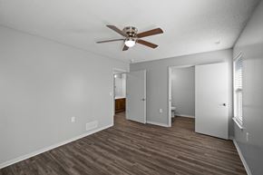 Lees Summit apartment for rent - A room with a ceiling fan and wood flooring.