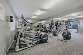 Lawrence apartment for rent - A gym with a variety of exercise equipment including treadmills, stationary bikes, and weight machines.