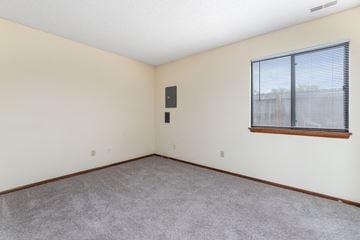 Lawrence apartment for rent - the living room of an apartment with carpet and a large window
