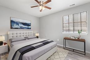 Lawrence apartment for rent - Bedroom with window, bed, and table at Eddingham in Lawrence, KS