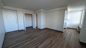 Omaha apartment for rent - an empty living room with wood floors and white walls