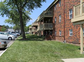 Columbia apartment for rent - a grassy area with a tree in front of a brick building