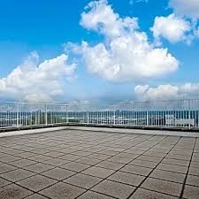 Kansas City apartment for rent - A rooftop with a grid of tiles and a metal railing.